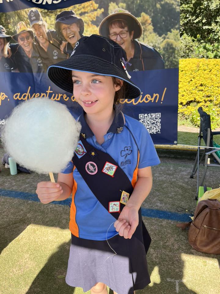 Girl Guide enjoying fairy floss at the festival